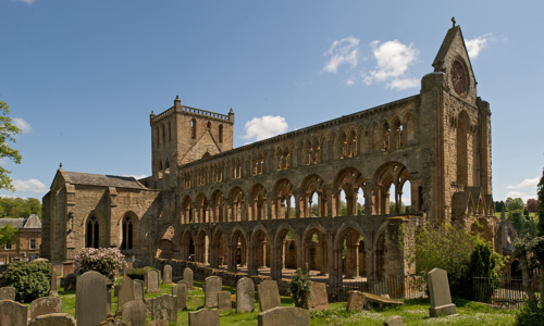 The outside of Jedburgh Abbey on a sunny day