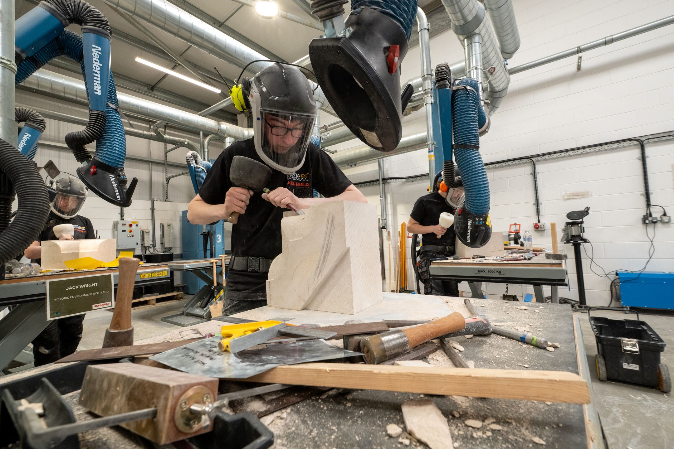 Stonemasons working at dedicated areas as part of a competition