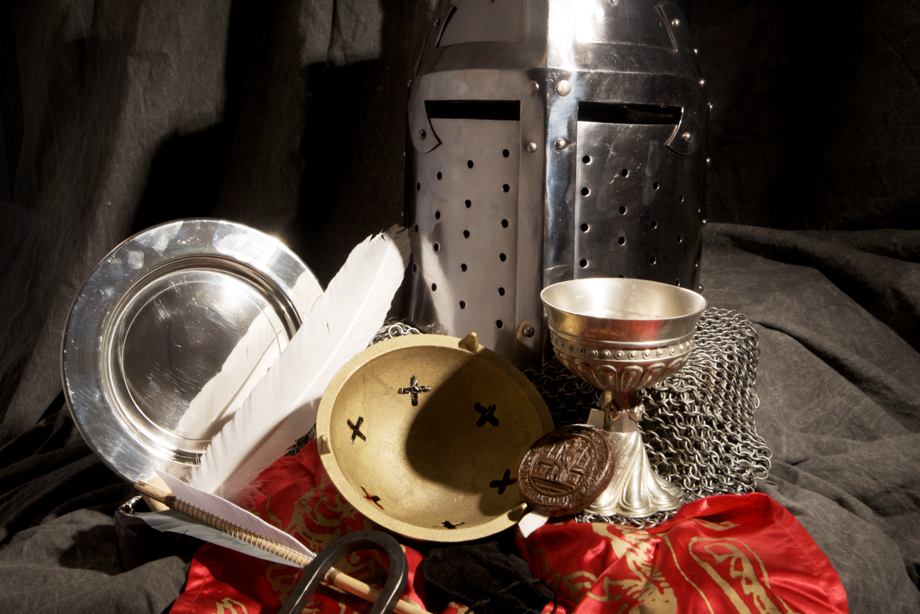 The various items from Castle Life handling box (helmet, plate, goblet, quill, manacles, arrow, chainmail) in an artistic pile.