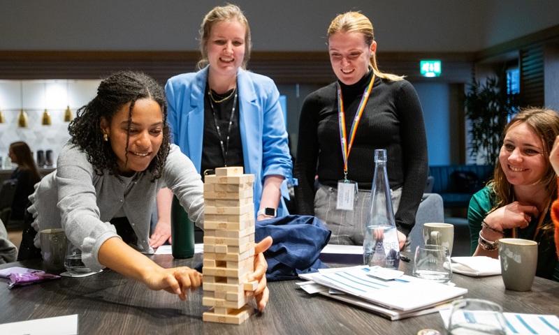 Colleagues sitting around a yenga tower