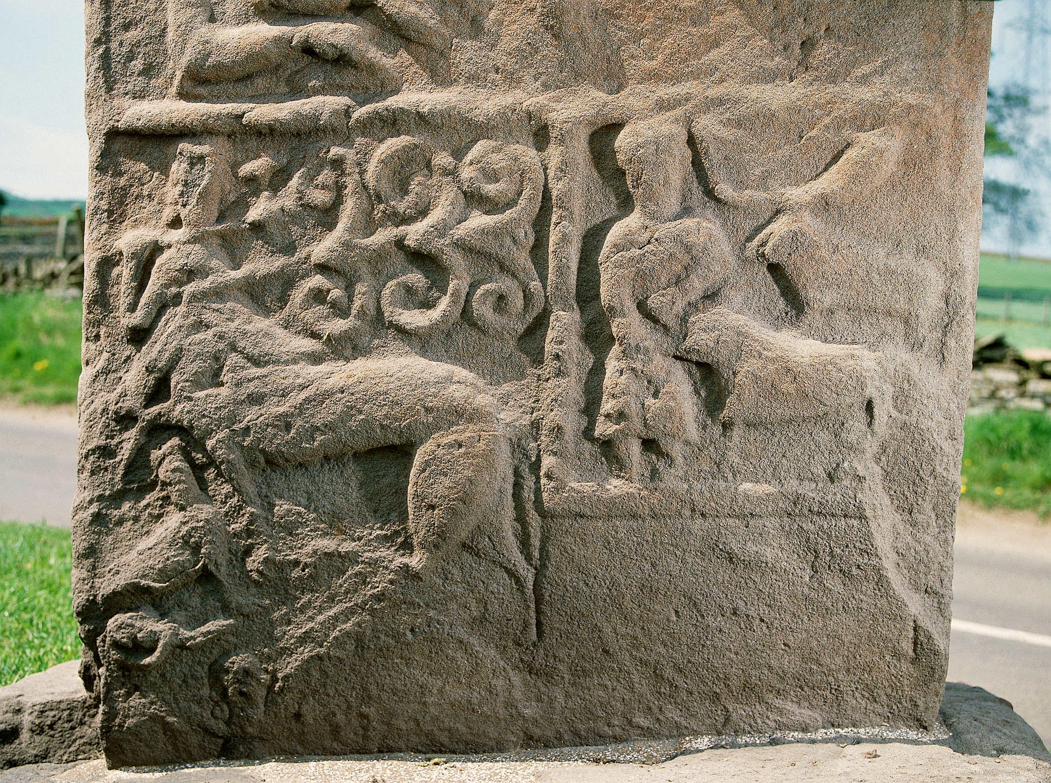 Close-up of sculptured stone showing a lion and a deer