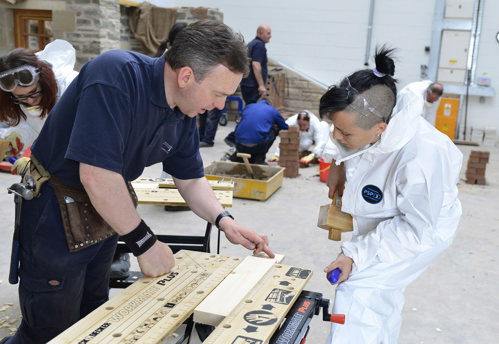 Participants at the Technical Conservation Summer School, getting an introduction to traditional building materials and their repair and maintenance through a hands on session