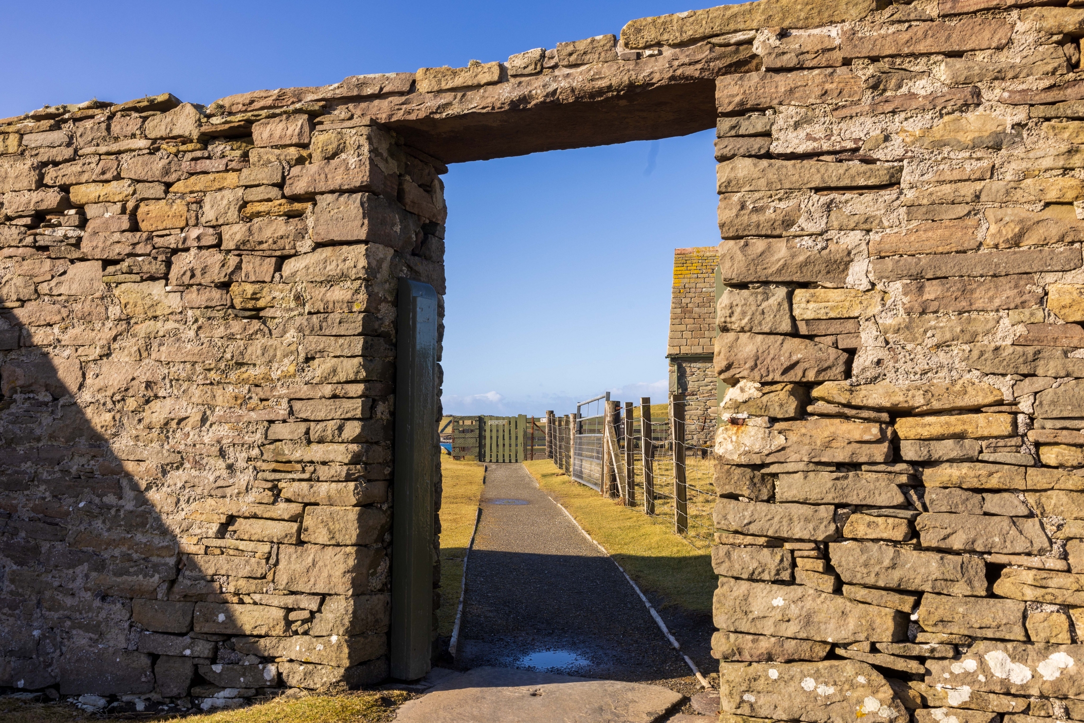 Stone wall with rectangular entrance way with path through