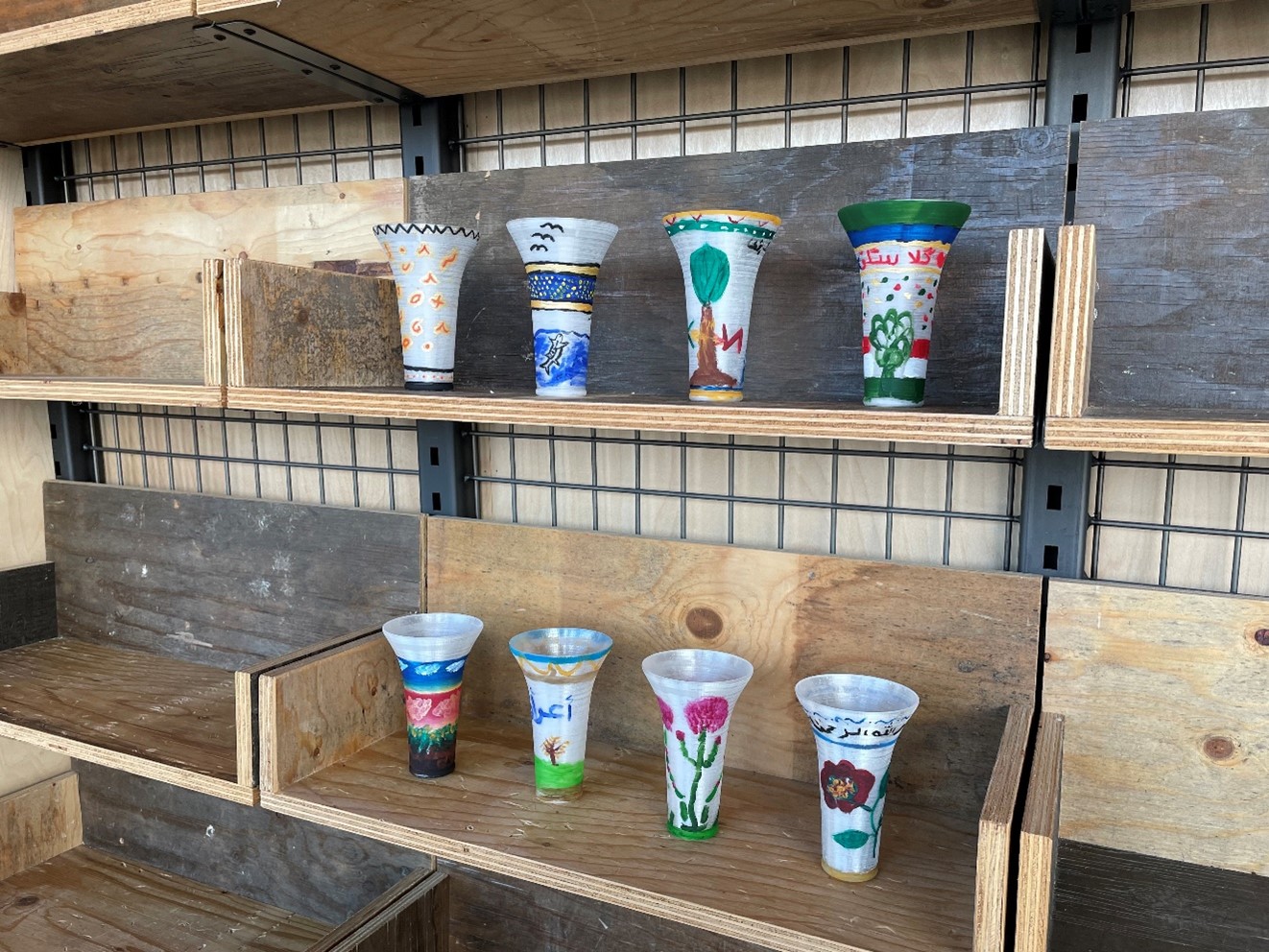 Two rows of 3D model beakers, all painted by a Kurdish women