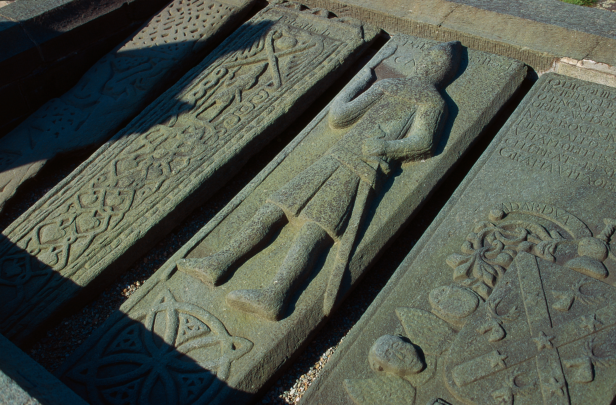 Close up of Kilmartin stones lying down. They are richly carved. 
