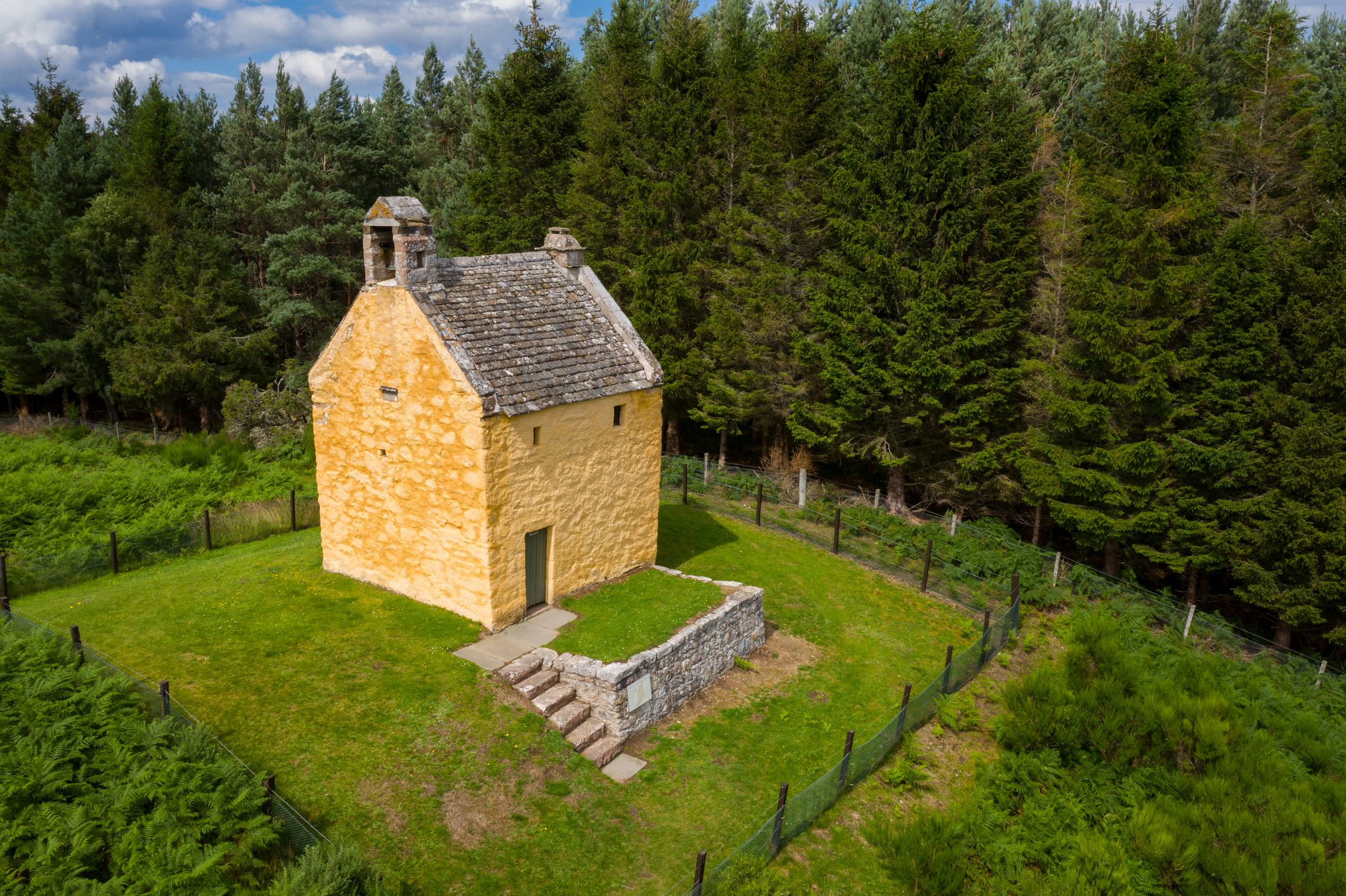 Aerial view overlooking Ardclach Bell Tower surrounded by the woods