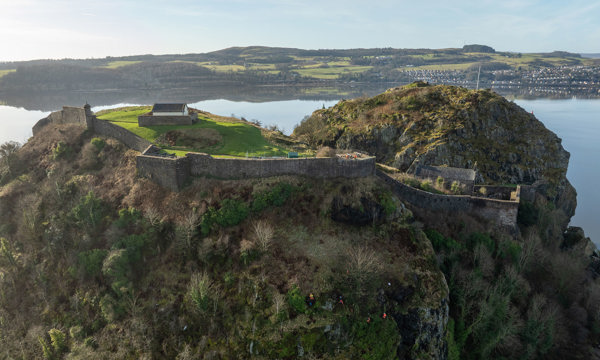 A rope access team working on carrying out de-vegetation on a rock face