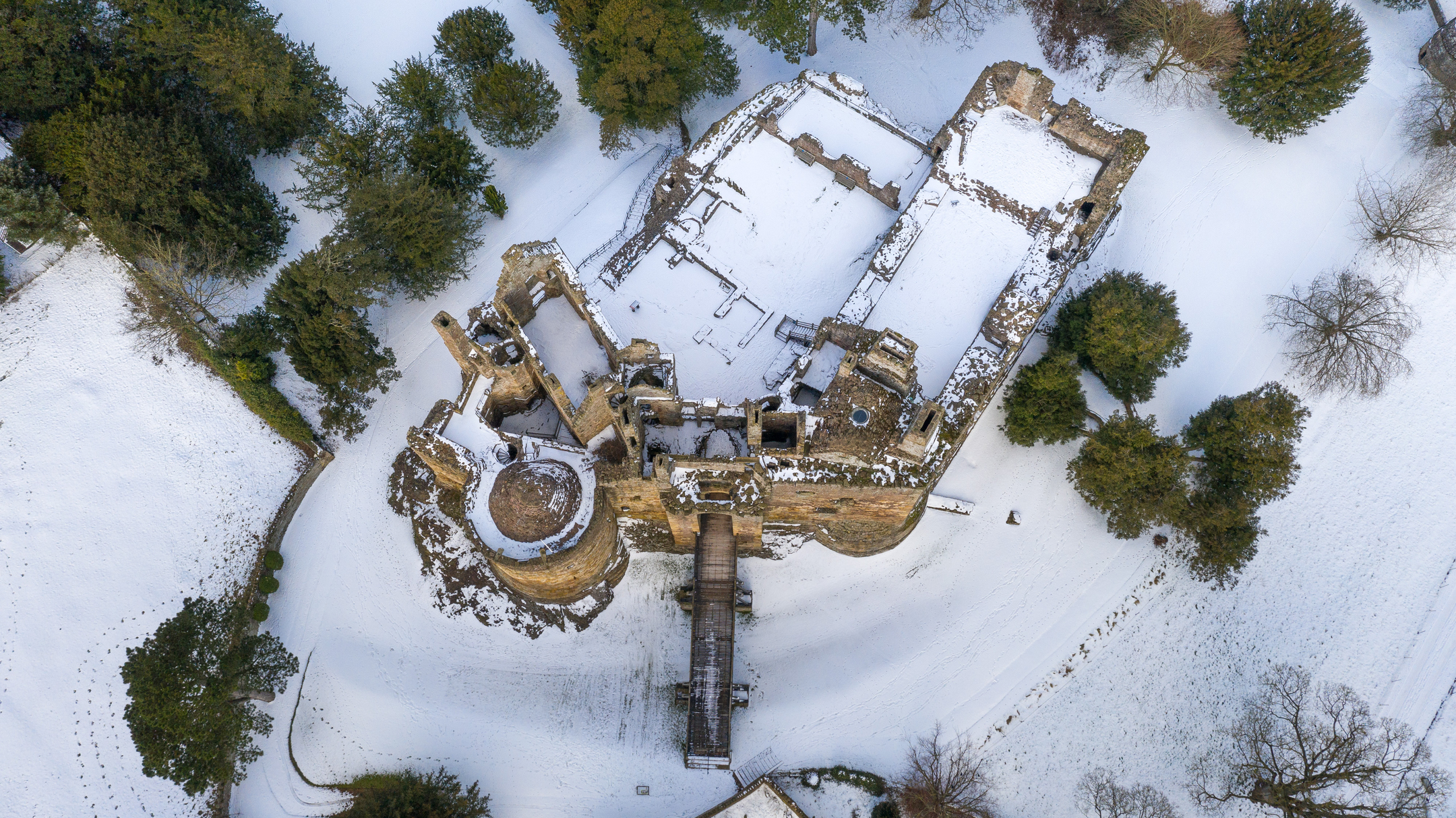 Well-preserved castle ruin after snowfall from directly above