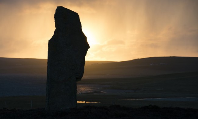 A single standing stone is highlighted by the setting stone