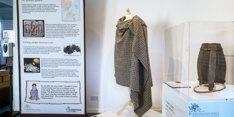 An information board is shown in the background and also a clothing display 