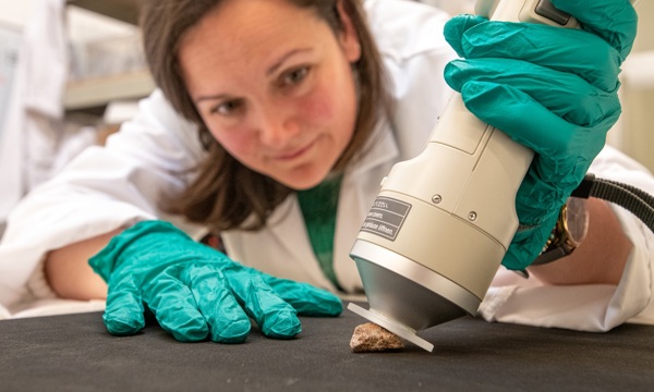 A scientist examines a fragment of the Stone of Destiny