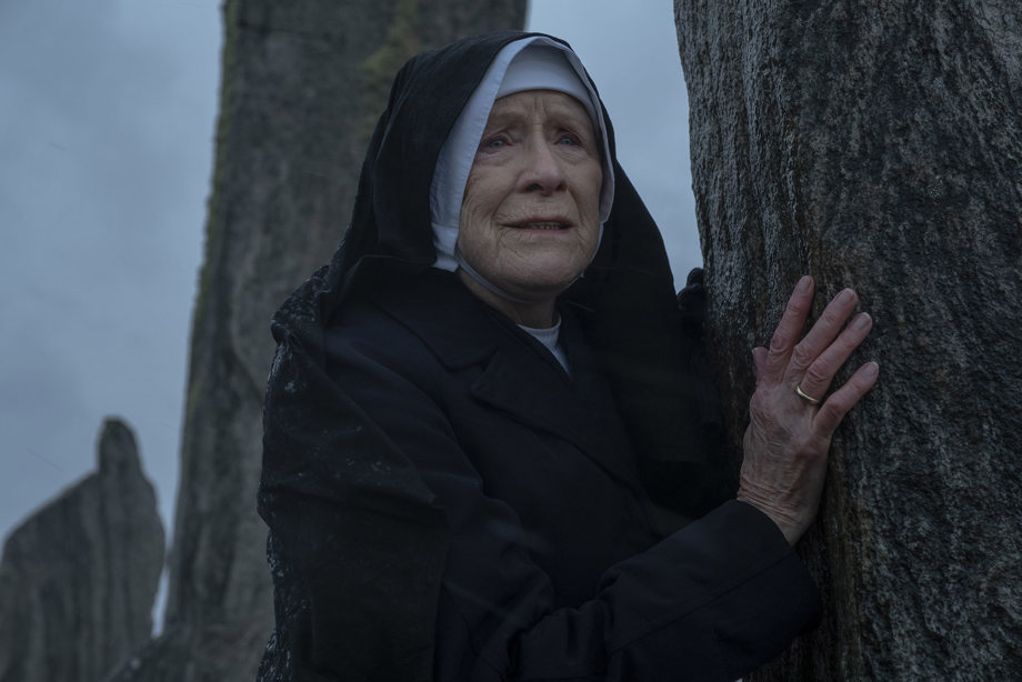 Judy Parfitt (as Sister Monica Joan in Call the Midwife) leaning against a standing stone at Calanais Standing Stones on the Isle of Lewis