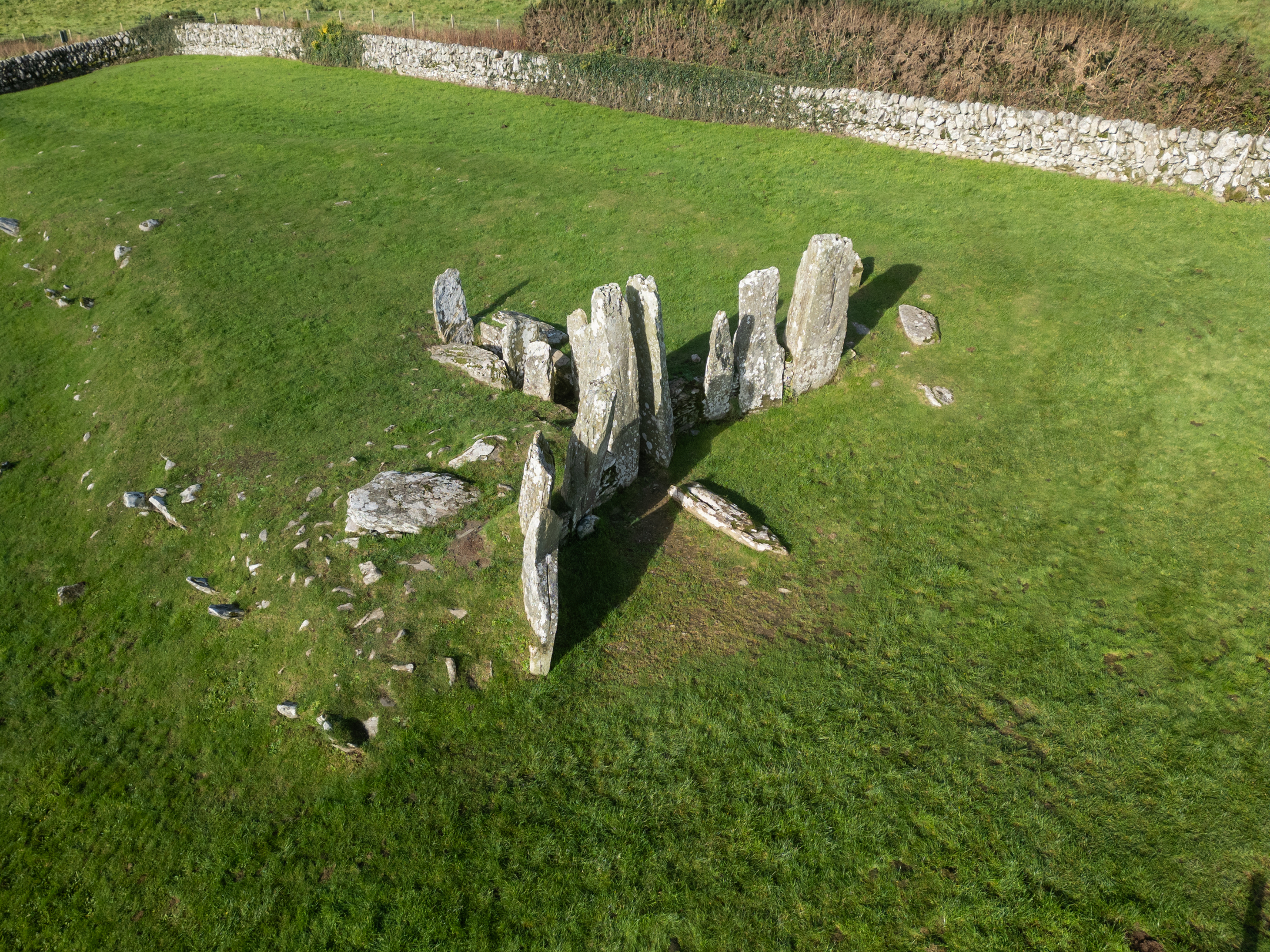 Aerial view over ragged stones standing upright on a meadow. 
