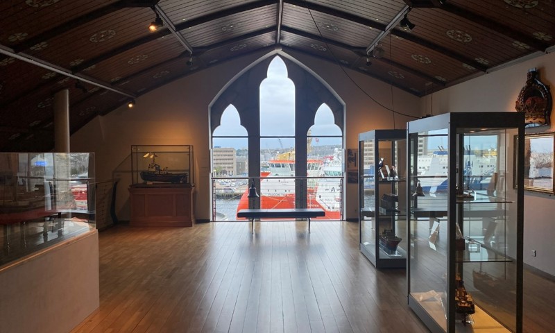 The interior of a museum with glass cases showing artefacts