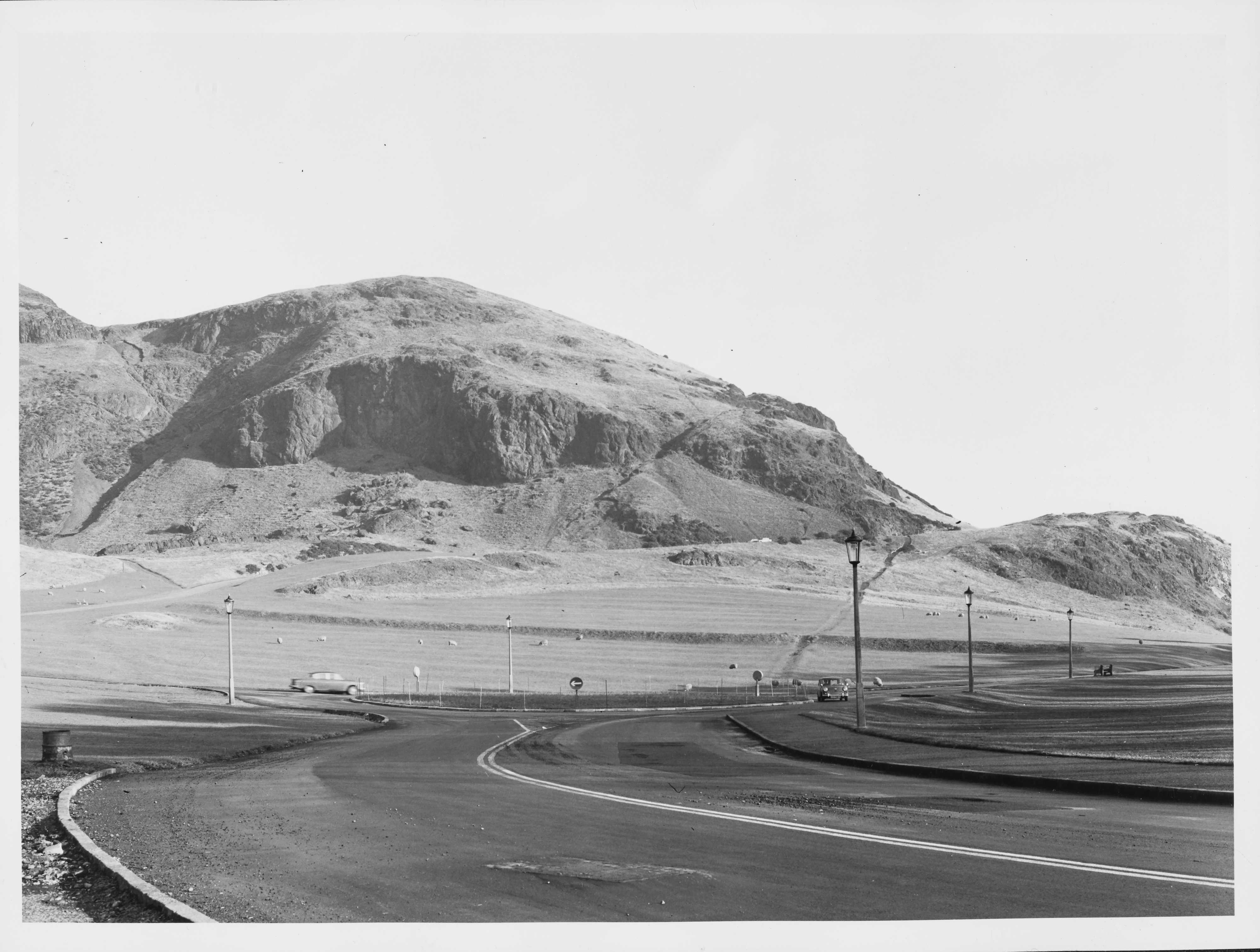 Black and white photo of Holyrood Park from road at bottom