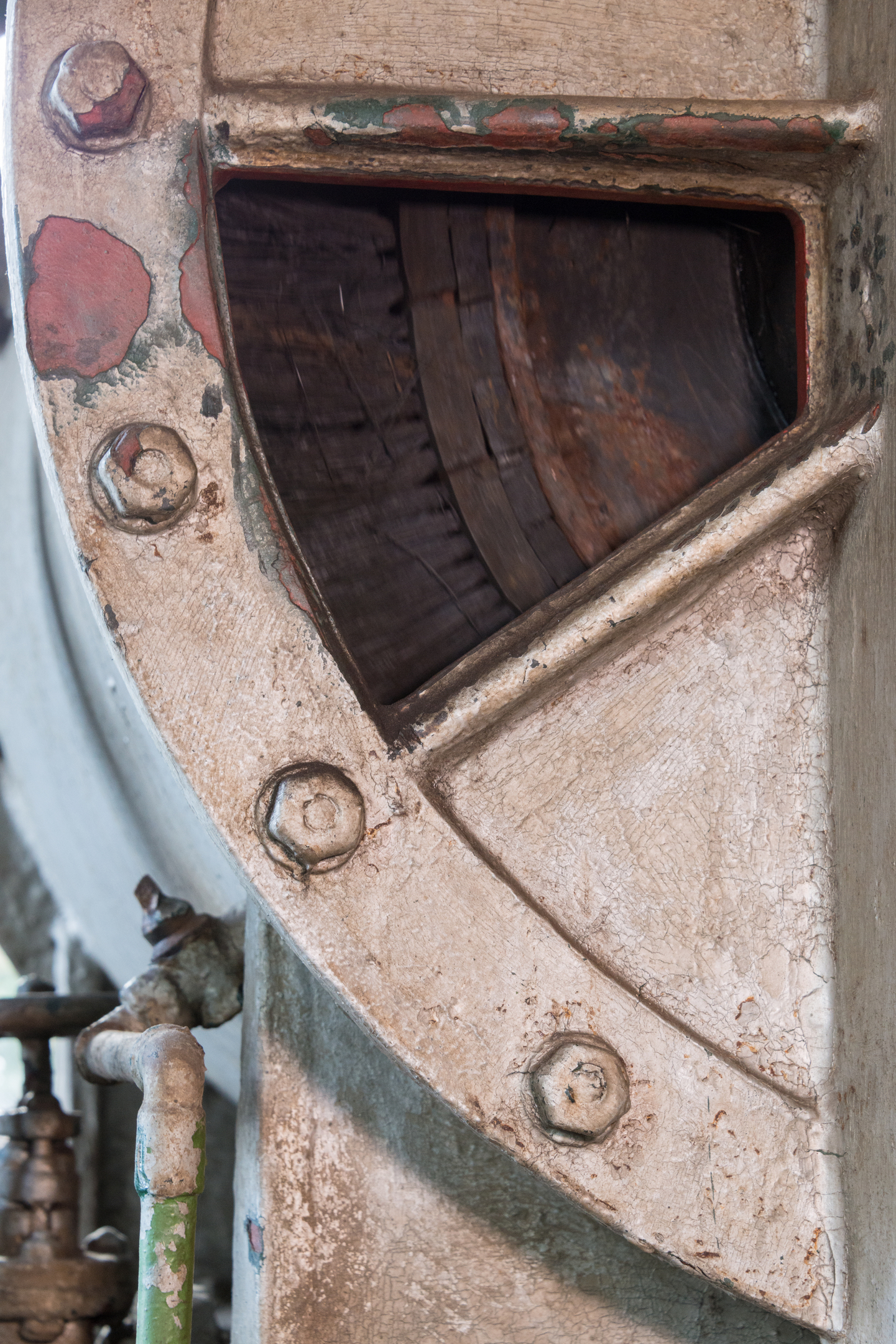 Close-up of historical machinery at Biggar Gasworks with a pipe. 