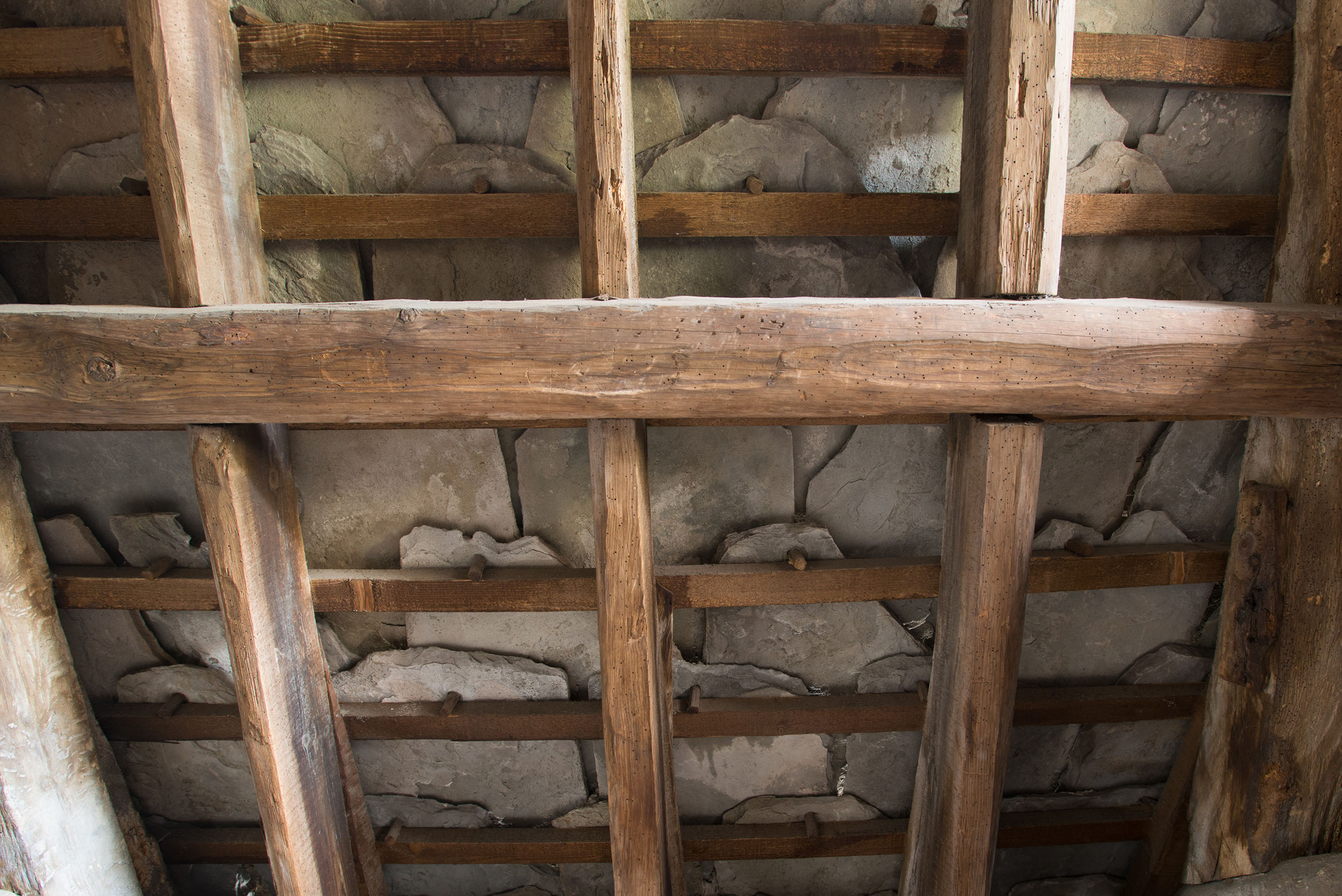 Interior view of Angus flagstone roofing, grey slabs laid over over wooden beams