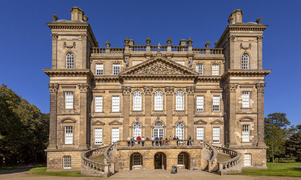 Exterior view of a Georgian mansion with clear blue skies