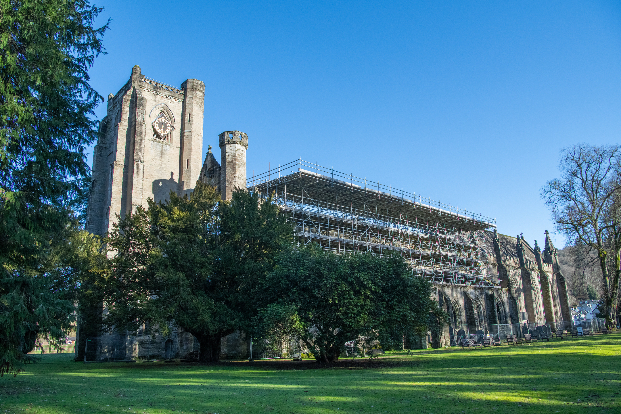 A large historic cathedral undergoing conservation work with scaffolding erected on its exterior.