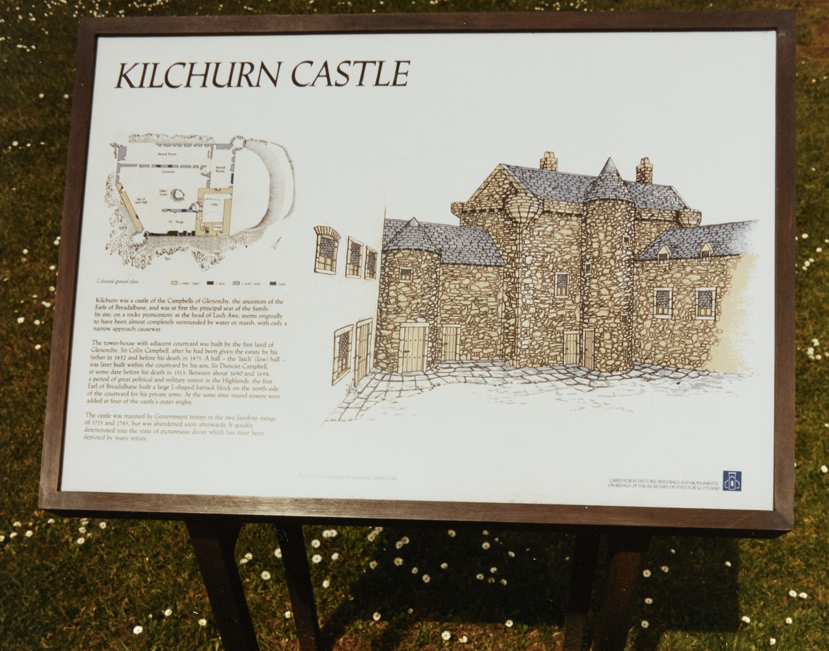 An old interpretation panel with information about the castle