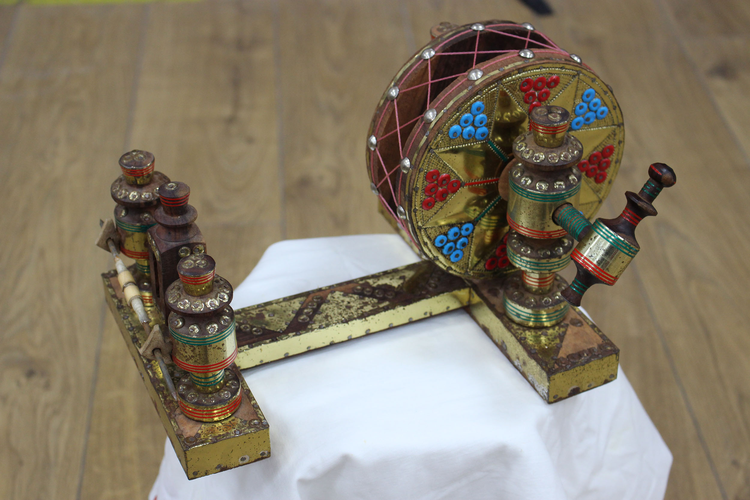 A decorative cotton machine with gold, red, green and blue detailing
