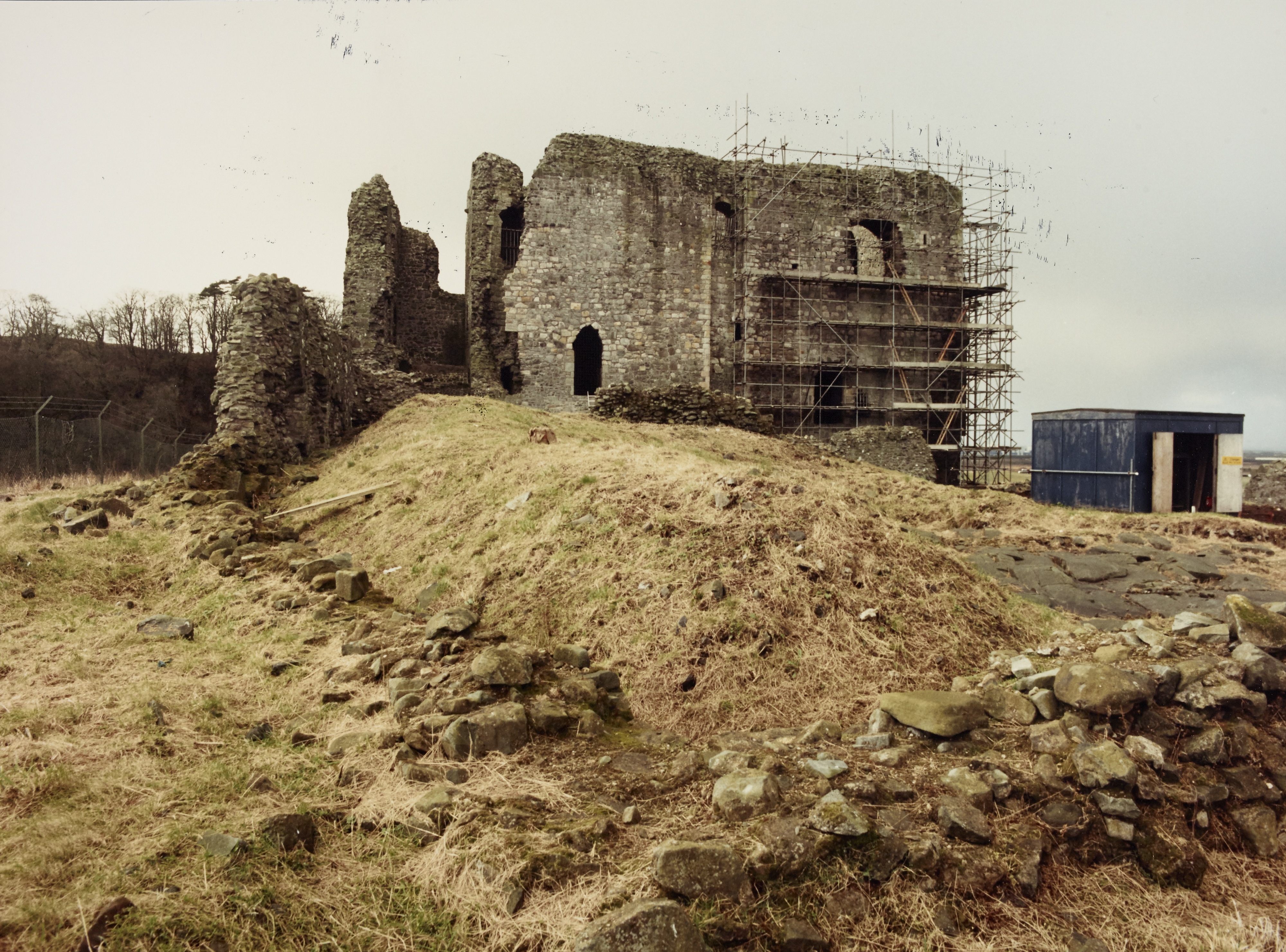 Castle with scaffolding on righ hand side and small temporary building on the right
