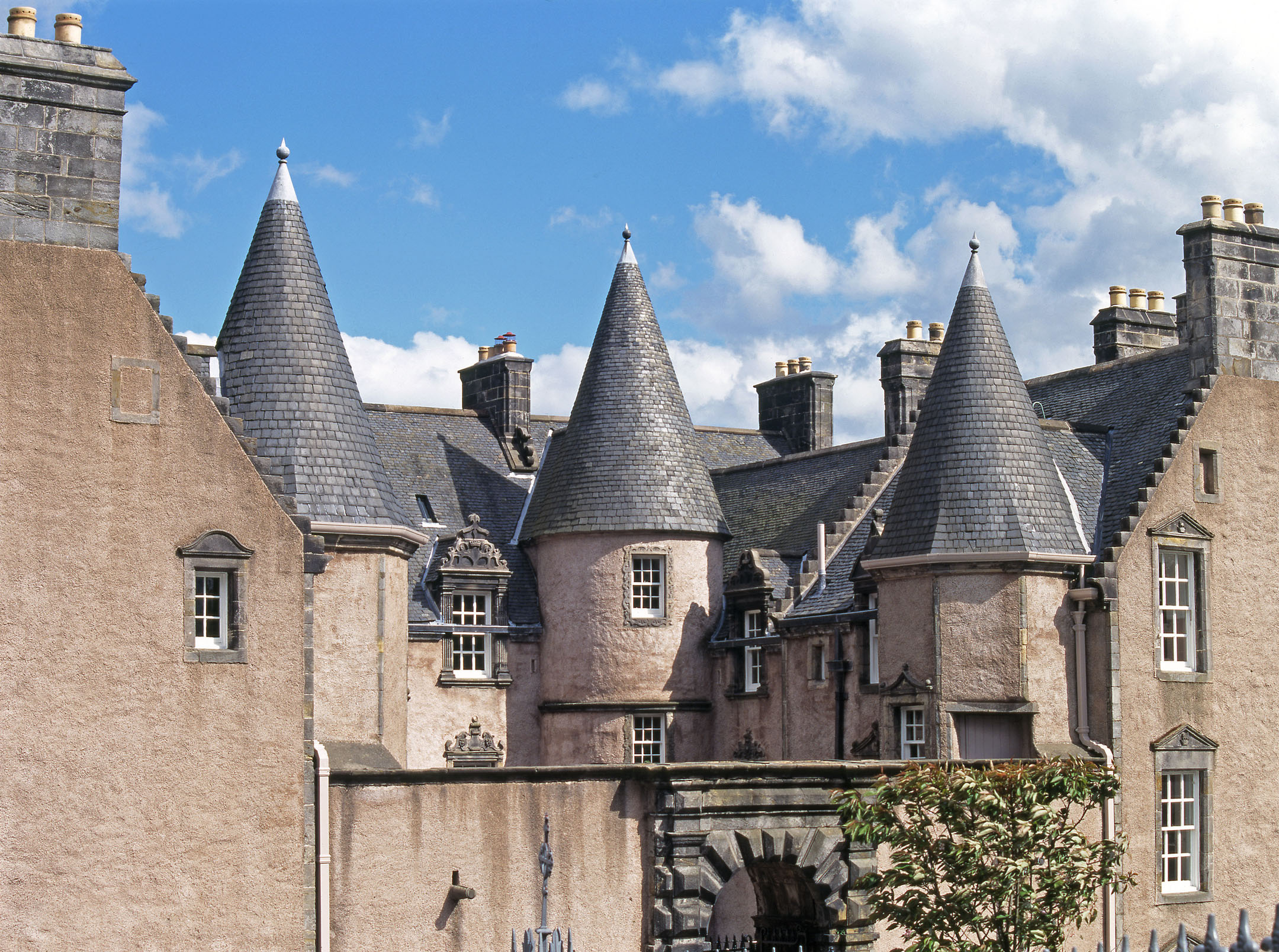 Close view of turrets and slate roof of Argyll's Lodging under blue sky.