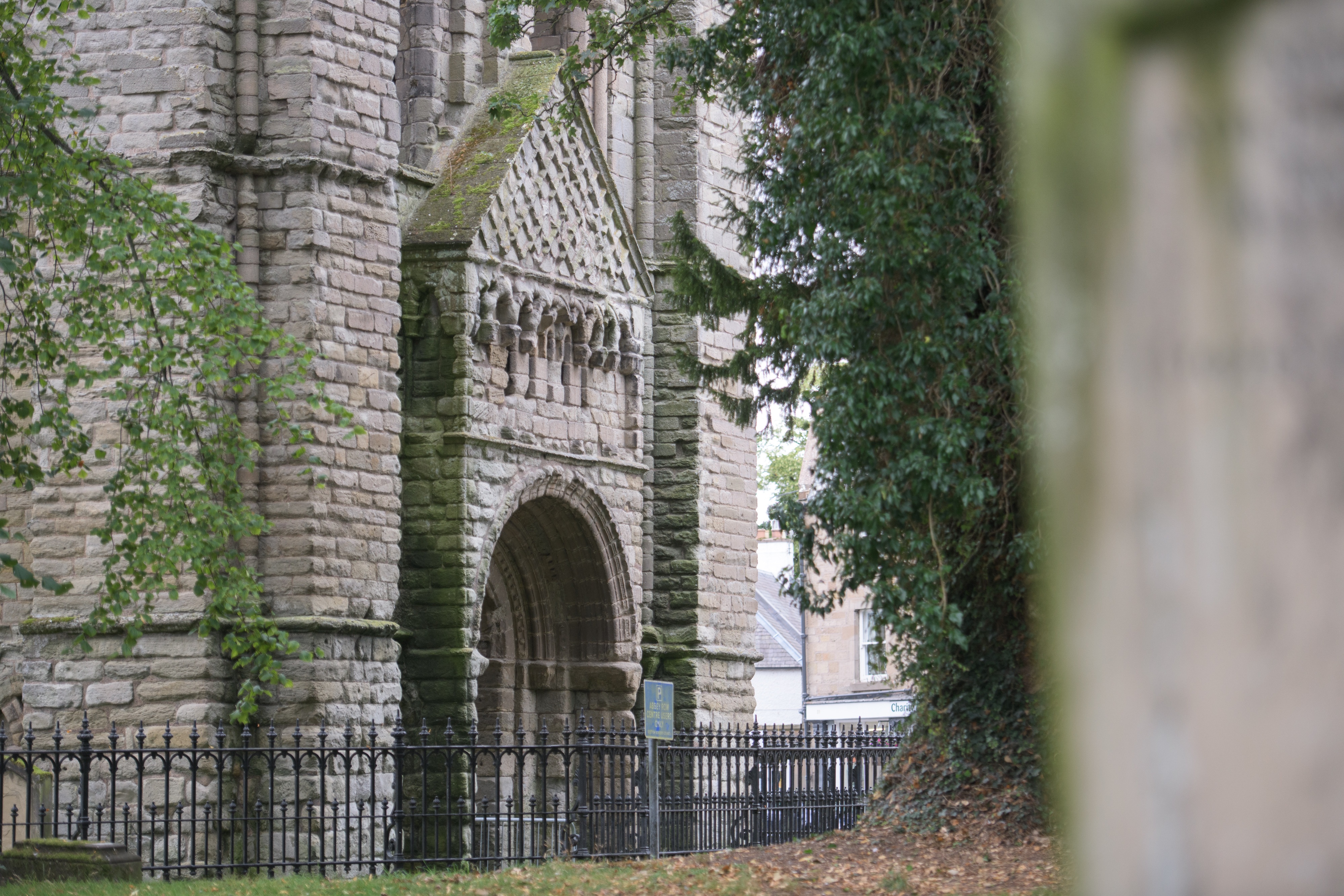 A large, decorative stone entrance on a historic abbey ruin