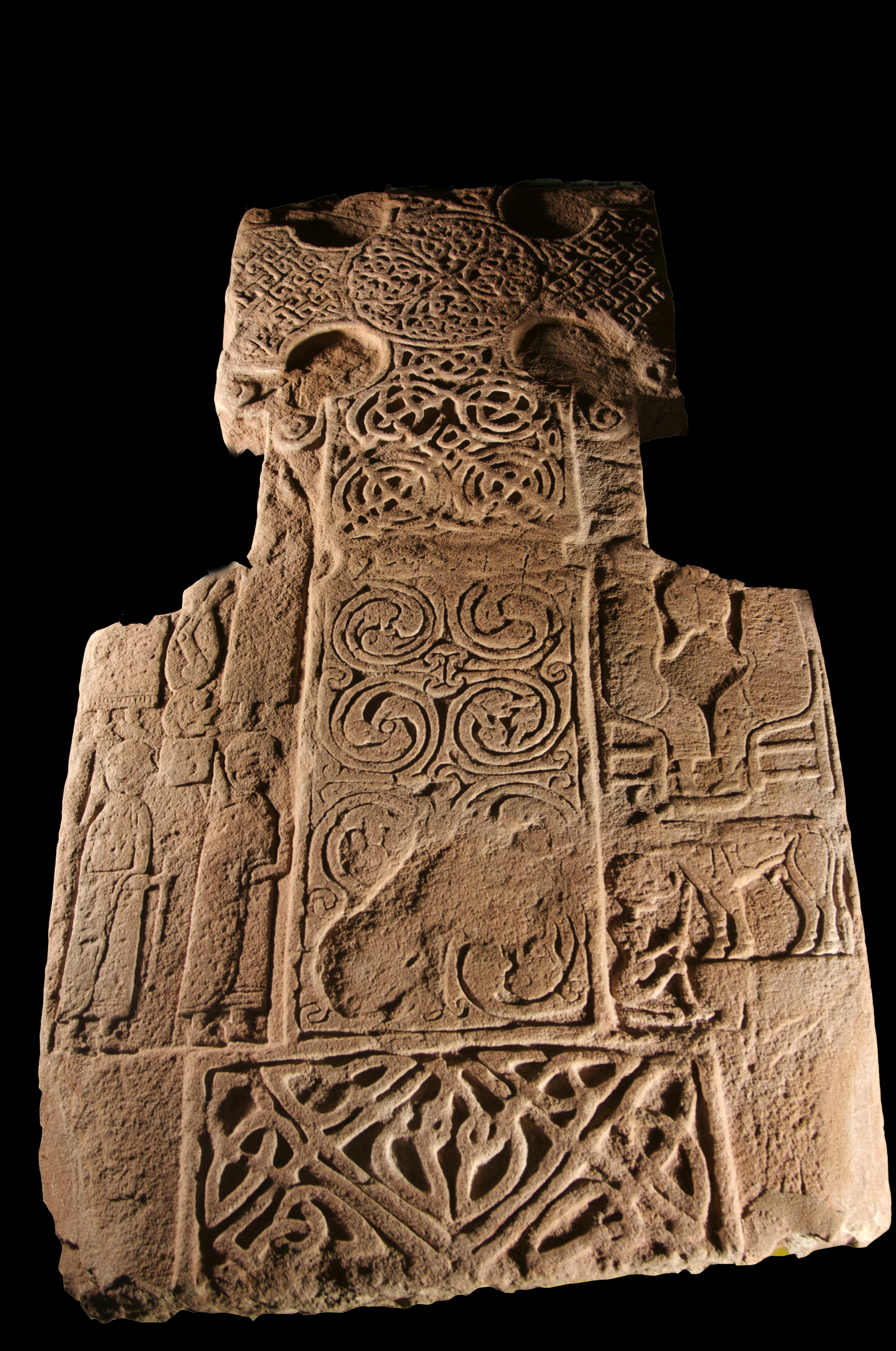 Ornate historic carved stone set against a black background