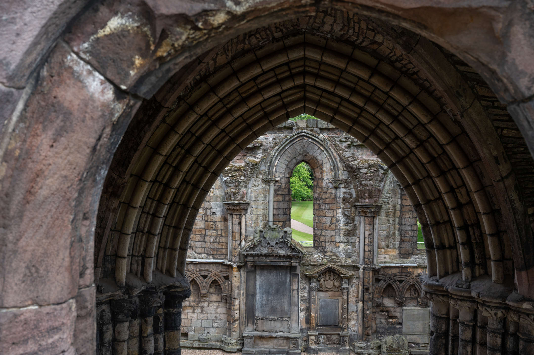 A view through an old stone archway with the nave of the abbey beyond