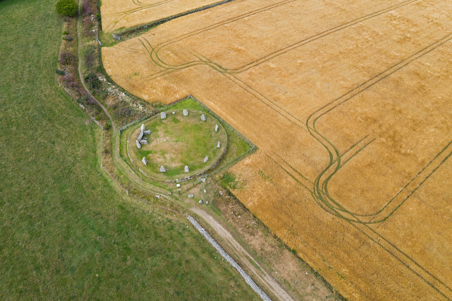 A large field, divided in the centre by a stone circle, with a square outlining it.