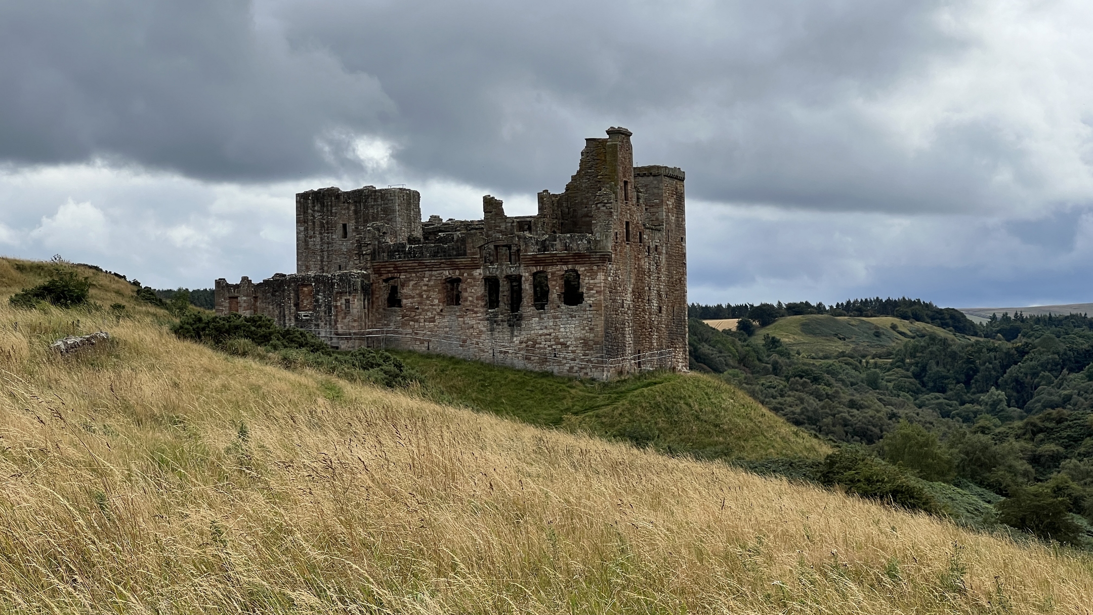 View of Crichton Castle on a slopped hill 