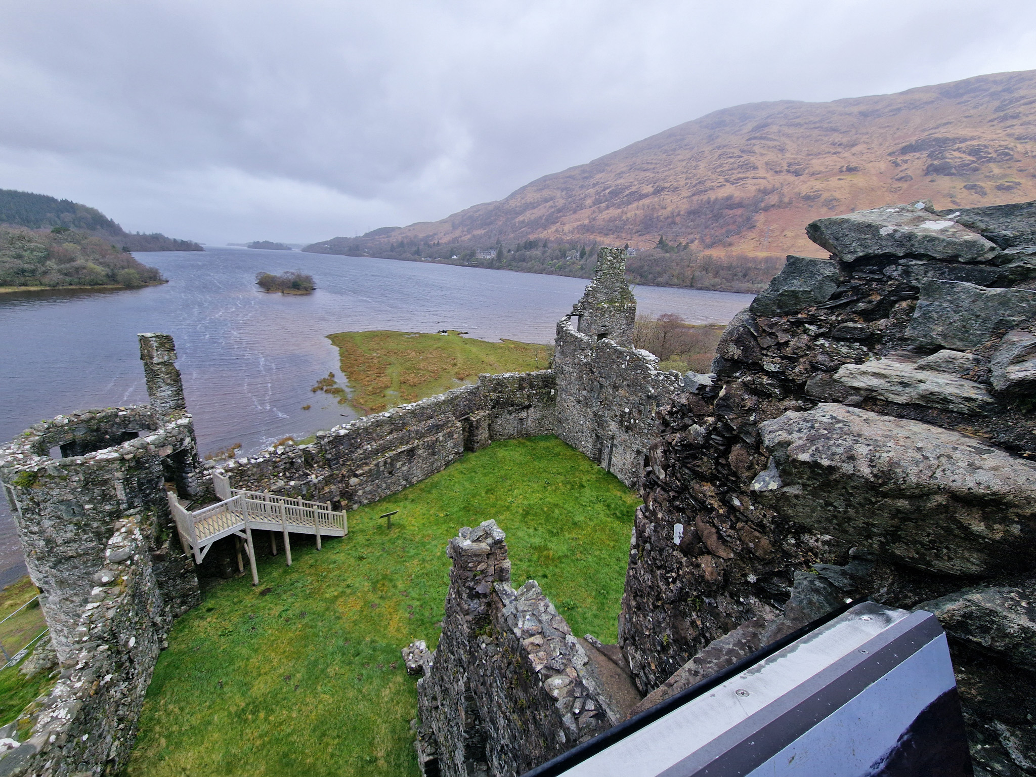 View from top of a castle ruin over a loch