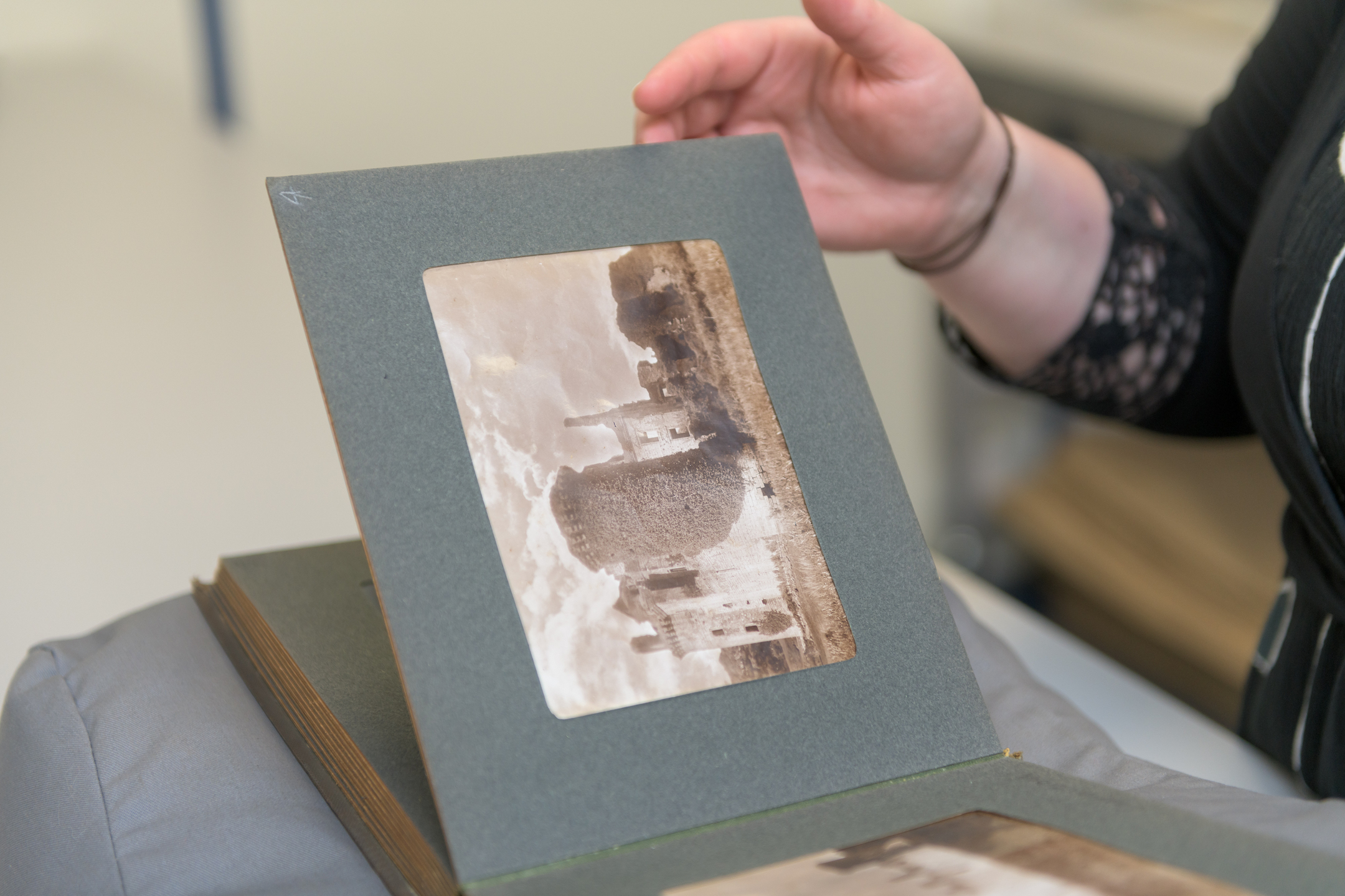 Photograph album with pages being turned by a person's hand