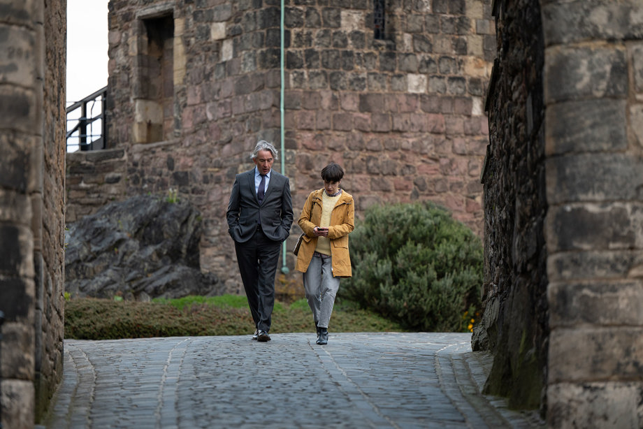 Two people walking down towards Foog's Gate, the steepest part of Edinburgh Castle