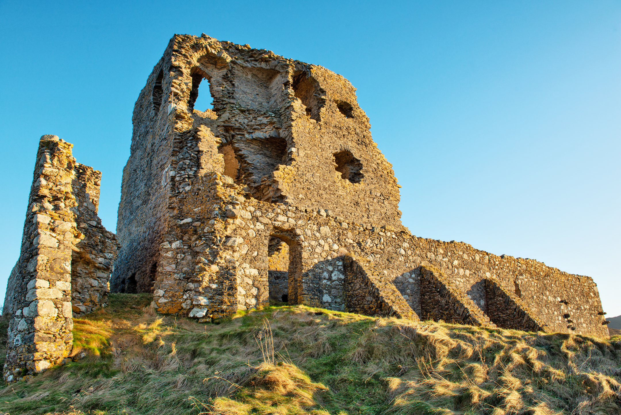 A tower or keep at a ruined castle. There a jagged holes and gaps where walls have fallen over the years. 